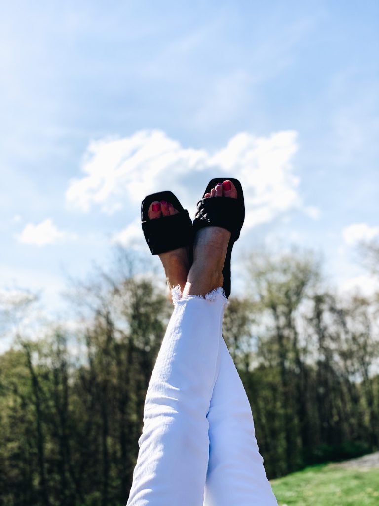 Top 7 Cute Spring Sandals for Women featured by top Pittsburgh fashion blogger, Fashionably Late Mom. |Spring Sandals by popular Pittsburgh fashion blog, Fashionably Late Mom: image of a woman wearing a pair of black slide sandals. 