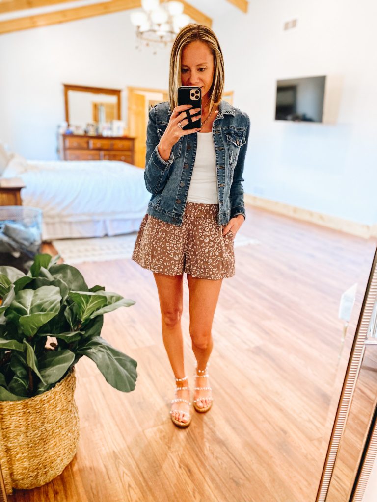 Top 7 Cute Spring Sandals for Women featured by top Pittsburgh fashion blogger, Fashionably Late Mom. |Spring Sandals by popular Pittsburgh fashion blog, Fashionably Late Mom: image of a woman wearing a denim jacket, white top, and leopard print shorts with clear strap studded sandals.  