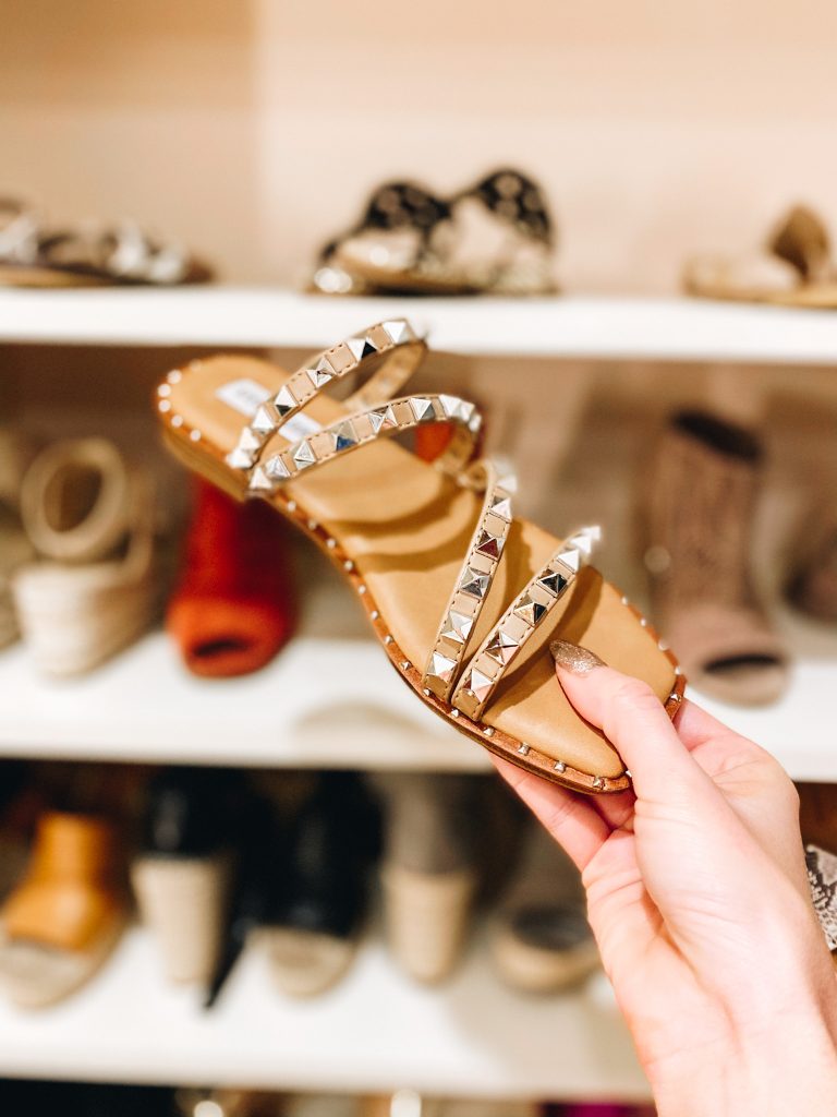 Top 7 Cute Spring Sandals for Women featured by top Pittsburgh fashion blogger, Fashionably Late Mom. |Spring Sandals by popular Pittsburgh fashion blog, Fashionably Late Mom: image of a woman holding a pair of studded sandals. 