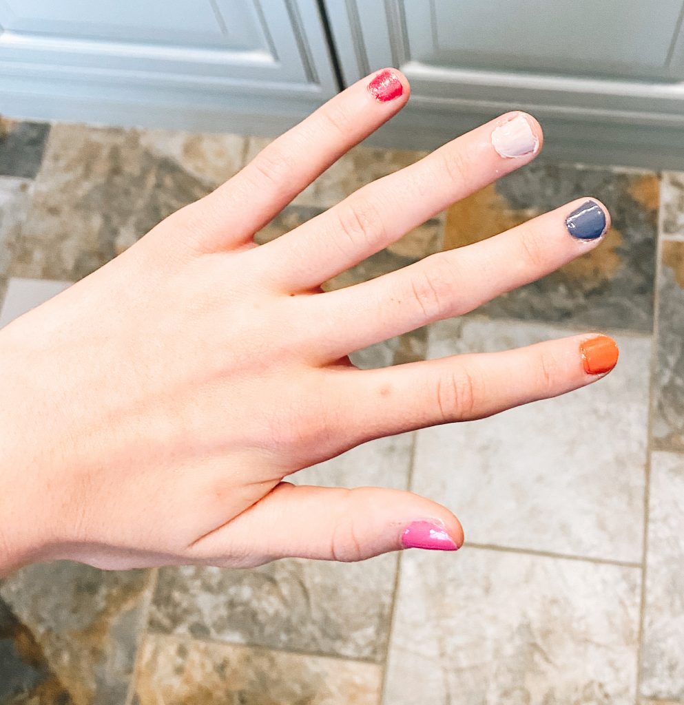 5 Hottest Summer Nail Polish Colors to Wear this Season featured by top Pittsburgh lifestyle blogger, Fashionably Late Mom |Summer Nail Polish by popular Pittsburgh beauty blog, Fashionably Late Mom: image of a woman's nails painted pink, orange, white, red, and blue.