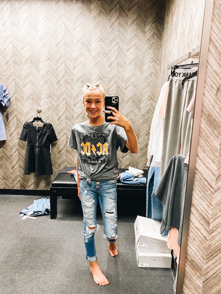 Nordstrom Anniversary Sale 2021: Try On Edition featured by top Pittsburgh fashion blogger, Fashionably Late Mom | Nordstrom Anniversary Sale by popular Pittsburgh fashion blog, Fashionably Late Mom: image of a teenage girl wearing a Nordstrom AC/DC t-shirt and distressed jeans. 