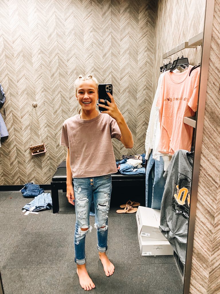 Nordstrom Anniversary Sale 2021: Try On Edition featured by top Pittsburgh fashion blogger, Fashionably Late Mom | Nordstrom Anniversary Sale by popular Pittsburgh fashion blog, Fashionably Late Mom: image of a teenage girl wearing a Nordstrom tan t-shirt and distressed denim. 