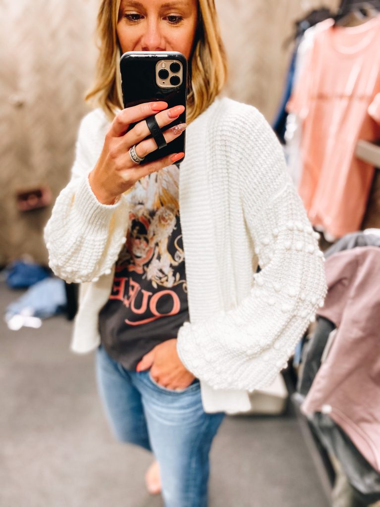 Nordstrom Anniversary Sale 2021: Try On Edition featured by top Pittsburgh fashion blogger, Fashionably Late Mom | Nordstrom Anniversary Sale by popular Pittsburgh fashion blog, Fashionably Late Mom: image of a woman wearing a Nordstrom tan knit sweater, Queen graphic t-shirt and light wash jeans. 