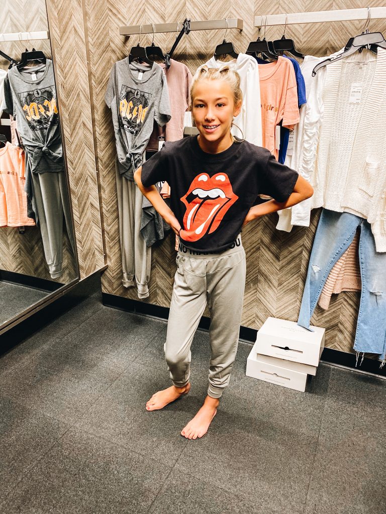 Nordstrom Anniversary Sale 2021: Try On Edition featured by top Pittsburgh fashion blogger, Fashionably Late Mom | Nordstrom Anniversary Sale by popular Pittsburgh fashion blog, Fashionably Late Mom: image of a teenage girl wearing a Nordstrom Rolling Stones t-shirt and grey jogger pants. 
