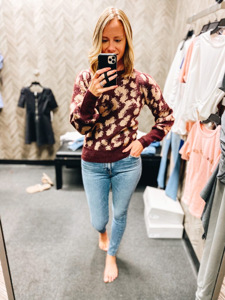 Nordstrom Anniversary Sale 2021: Try On Edition featured by top Pittsburgh fashion blogger, Fashionably Late Mom | Nordstrom Anniversary Sale by popular Pittsburgh fashion blog, Fashionably Late Mom: image of a woman wearing a Nordstrom maroon and tan leaopard print sweater and light wash jeans. 