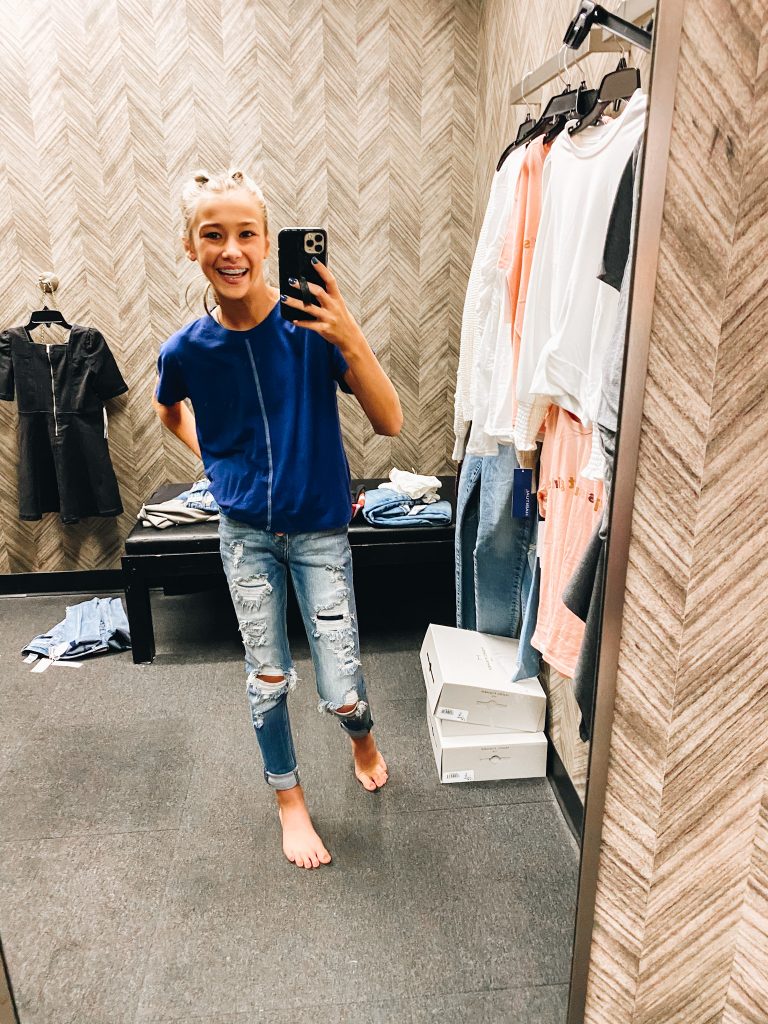 Nordstrom Anniversary Sale 2021: Try On Edition featured by top Pittsburgh fashion blogger, Fashionably Late Mom | Nordstrom Anniversary Sale by popular Pittsburgh fashion blog, Fashionably Late Mom: image of a teenage girl wearing a Nordstrom blue shirt and distressed jeans. 