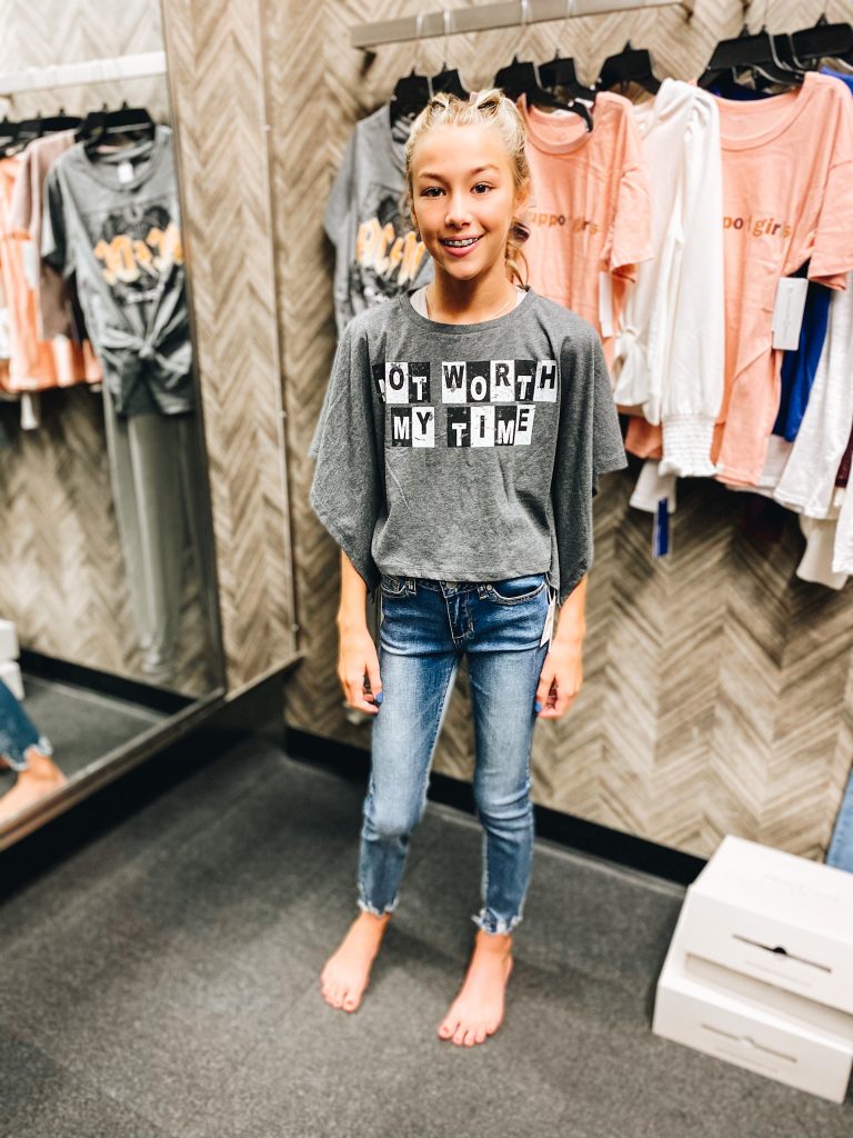 Nordstrom Anniversary Sale 2021: Try On Edition featured by top Pittsburgh fashion blogger, Fashionably Late Mom | Nordstrom Anniversary Sale by popular Pittsburgh fashion blog, Fashionably Late Mom: image of a teenage girl wearing a Nordstrom not worth my time t-shirt and jeans. 