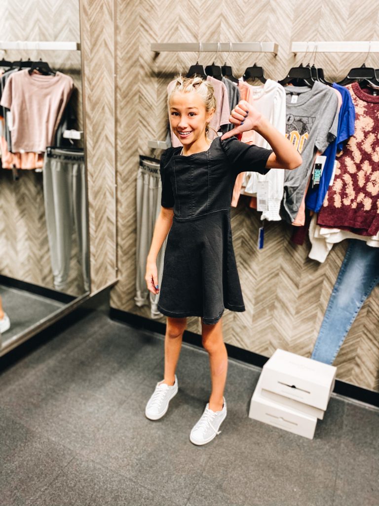 Nordstrom Anniversary Sale 2021: Try On Edition featured by top Pittsburgh fashion blogger, Fashionably Late Mom | Nordstrom Anniversary Sale by popular Pittsburgh fashion blog, Fashionably Late Mom: image of a teenage girl wearing a Nordstrom black dress and white sneaker. 