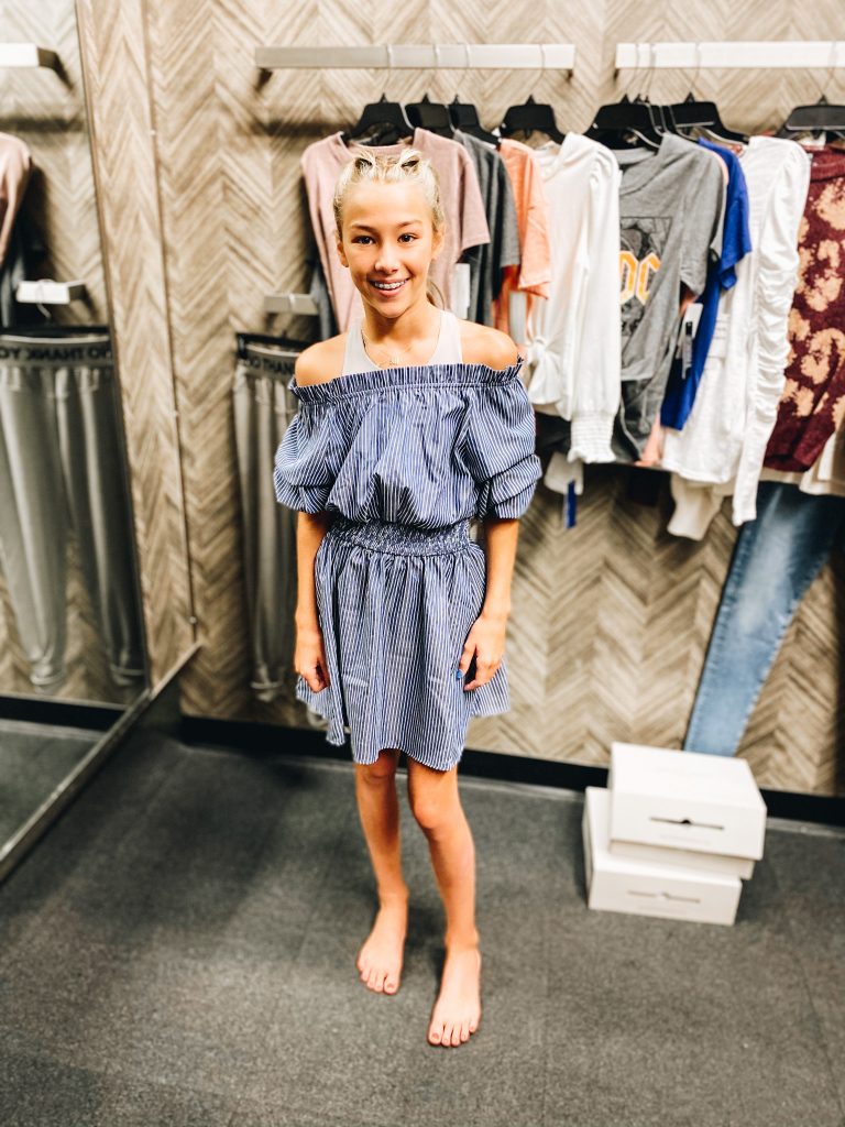 Nordstrom Anniversary Sale 2021: Try On Edition featured by top Pittsburgh fashion blogger, Fashionably Late Mom | Nordstrom Anniversary Sale by popular Pittsburgh fashion blog, Fashionably Late Mom: image of a teenage girl wearing a Nordstrom off the shoulder blue and white stripe dress. 