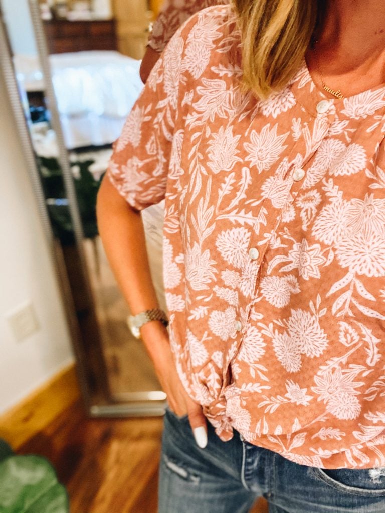 Working Mom Outfits by popular Pittsburgh fashion blog, Fashionably Late Mom: image of a woman wearing a fall floral crop top and distressed jeans. 