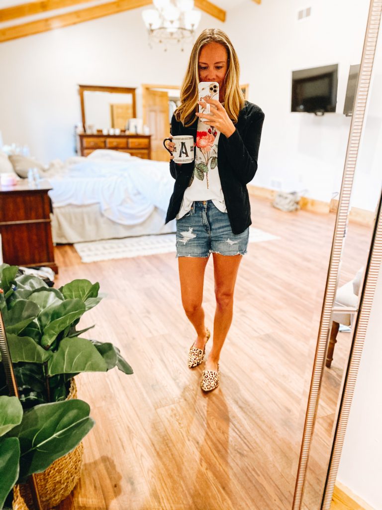 fashion for working moms, casual blazer, denim shorts, casual style | How to Style a Blazer by popular Pittsburgh fashion blog, Fashionably Late Mom: image of a woman wearing a floral graphic print t-shirt, black blazer, distressed denim shorts, and leopard print flats.