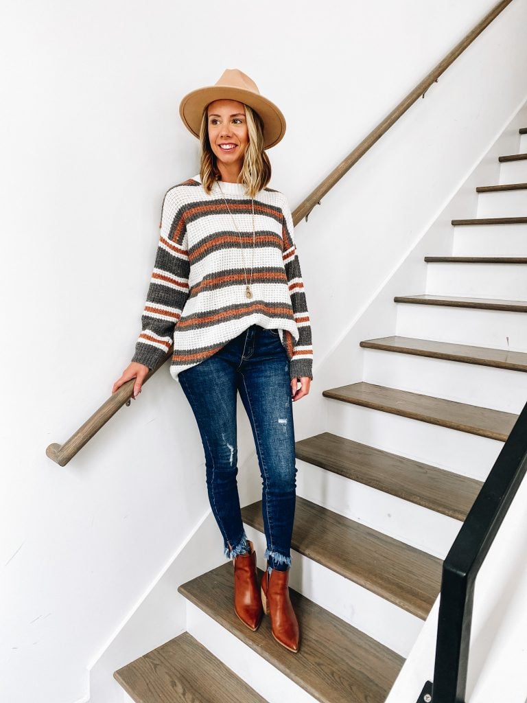 fall sweater, fall fashion, pink lily autumn awaits collection, brown booties | Pink Lily by popular Pittsburgh fashion blog, Fashionably Late Mom: image of a woman wearing a Pink Lilly striped sweater, tan felt fedora hat, distressed jeans, and brown ankle boots. 