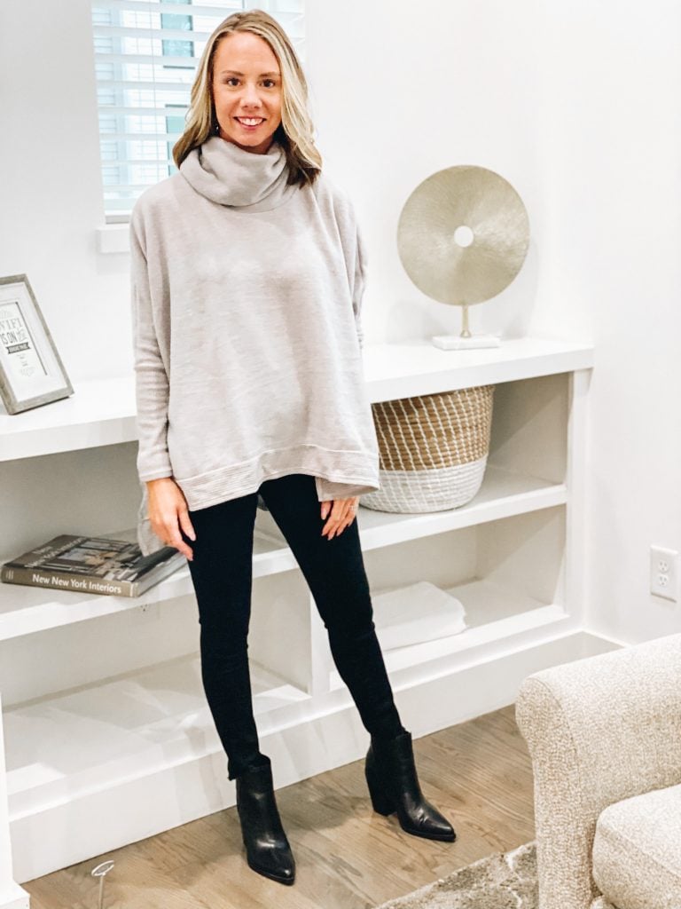 Pink Lily by popular Pittsburgh fashion blog, Fashionably Late Mom: image of a woman wearing a Pink Lilly  grey cowl neck sweatshirt, black jeans, and black ankle boots. 