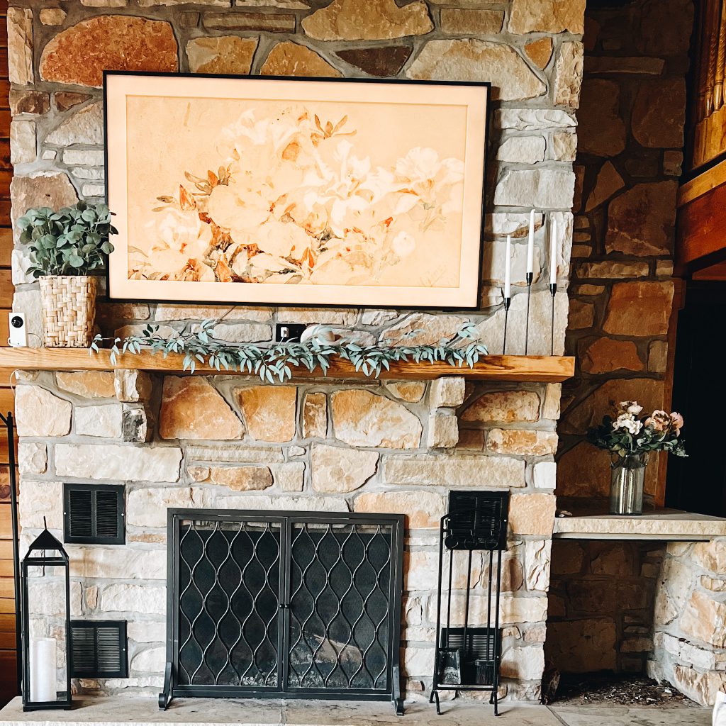 frame tv, target home, mantle garland, candles, log home, stone fireplace
