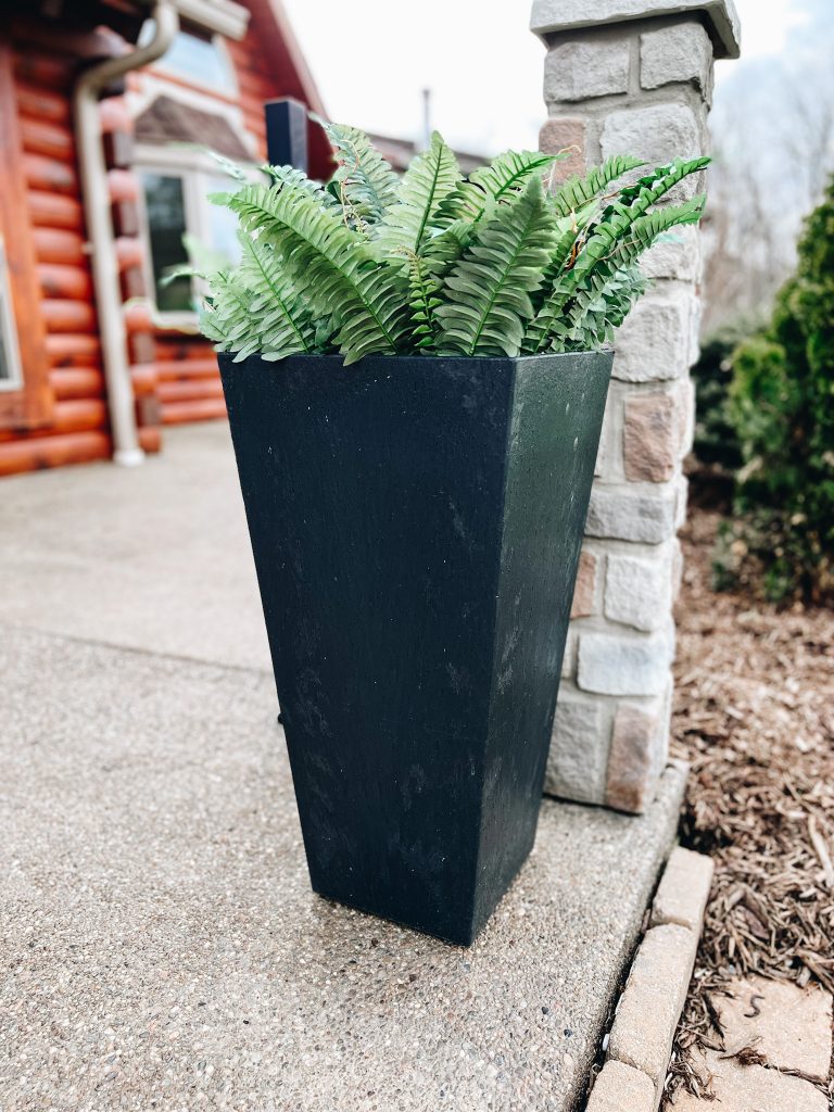 faux fern plants, black planter, log home porch, how to refresh your porch for spring