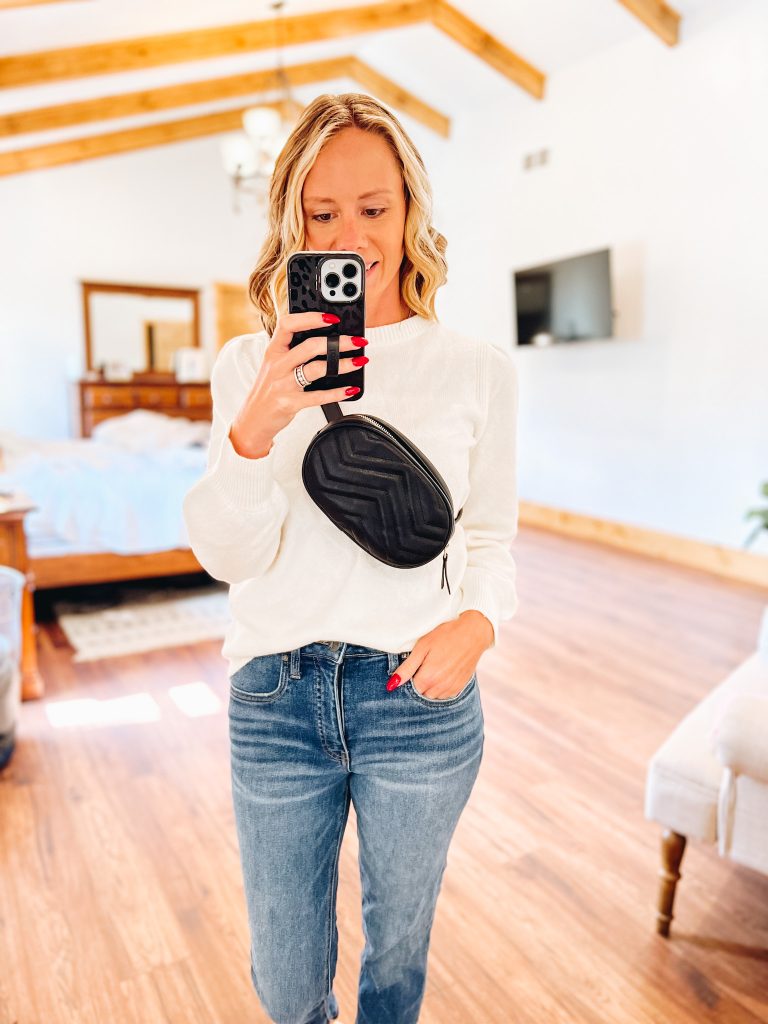 black belt bag, straight leg jeans, white amazon sweater