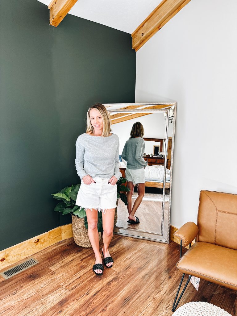 grey sweatshirt, white denim shorts, black slide sandals