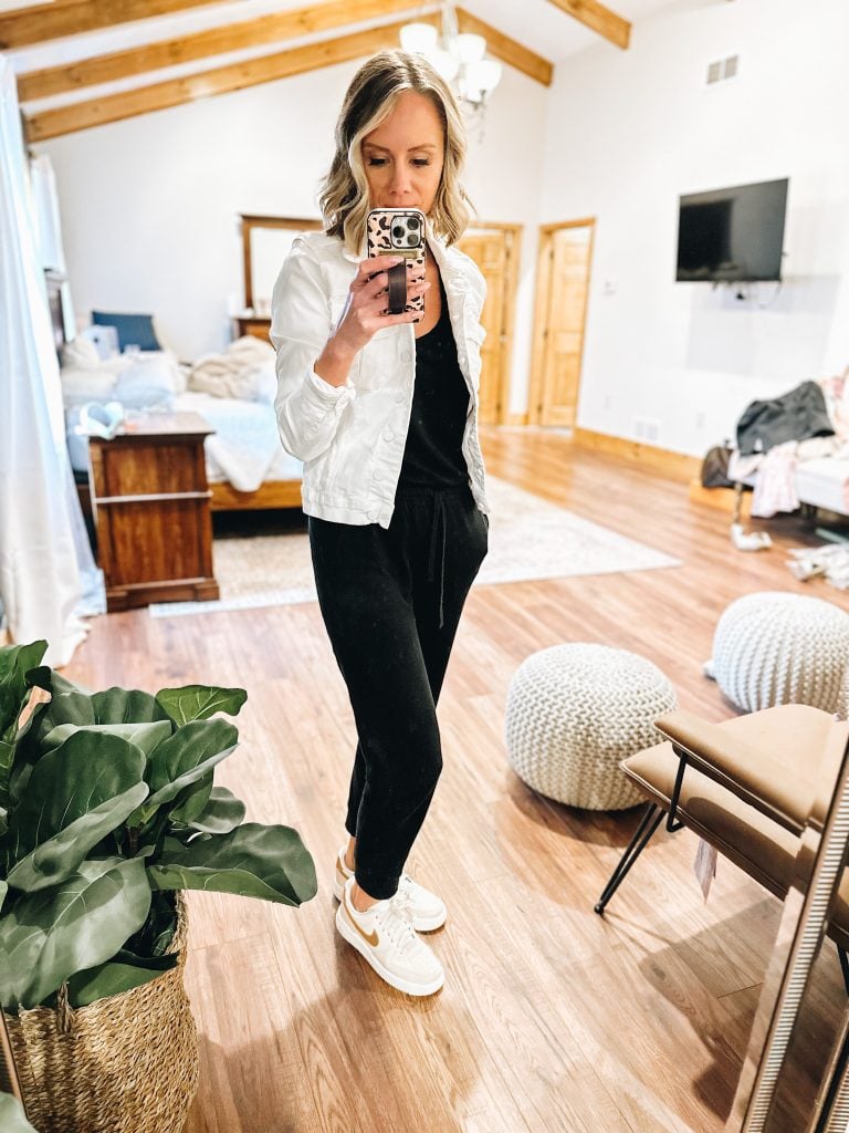 travel outfit idea, jumpsuit, denim jacket, air force one shoes, sneakers