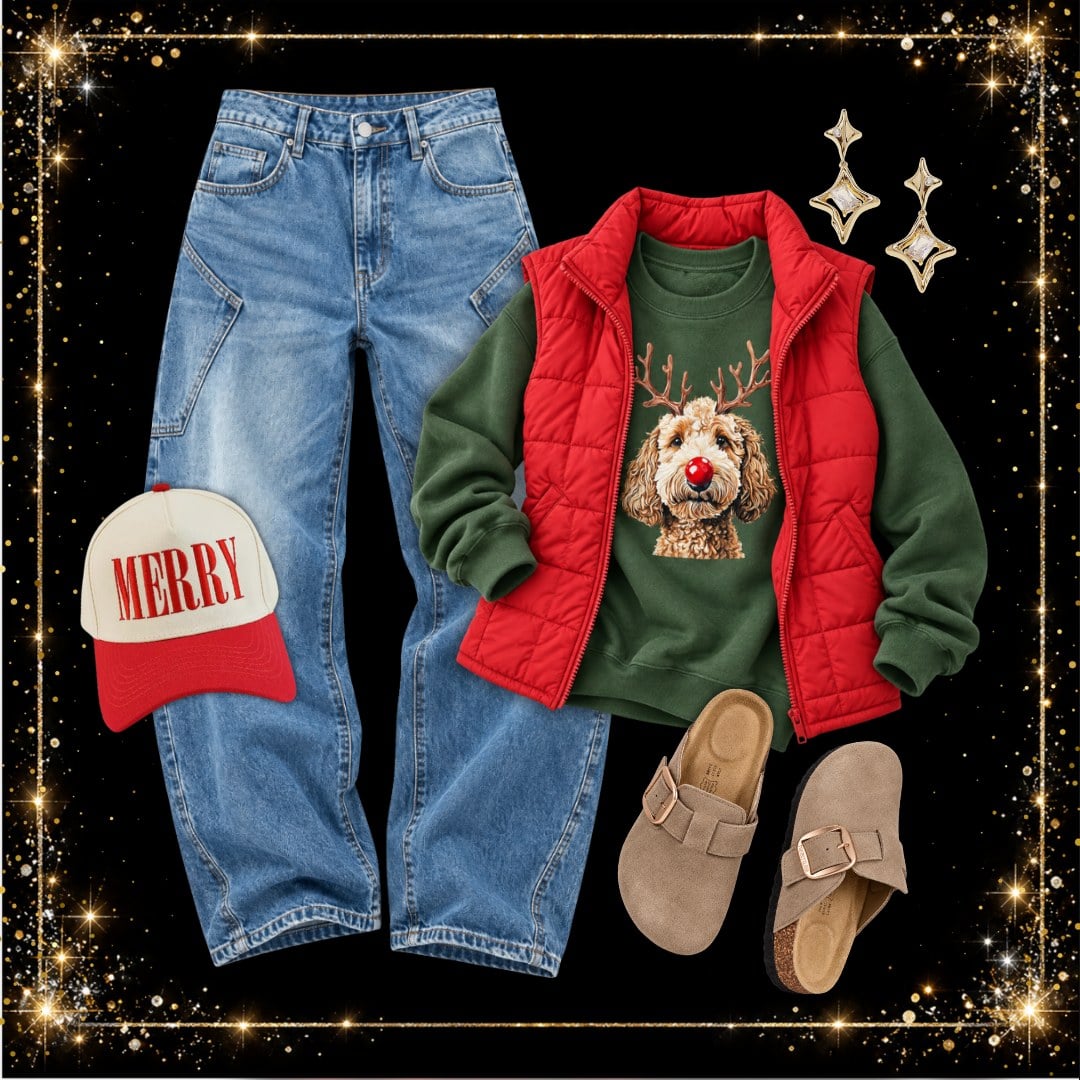 Christmas outfit with a green reindeer doodle graphic sweatshirt, red puffer vest, light wash wide leg jeans, MERRY trucker hat and tan clog sandals
